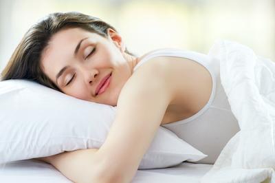 Woman smiling while sleeping on a pillow, fishers in